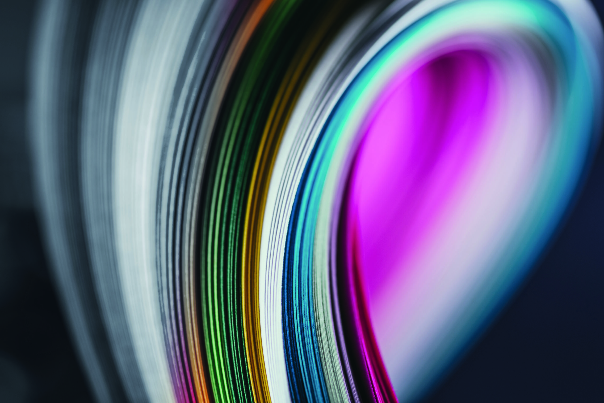 close up of colored bright quilling paper curves on black